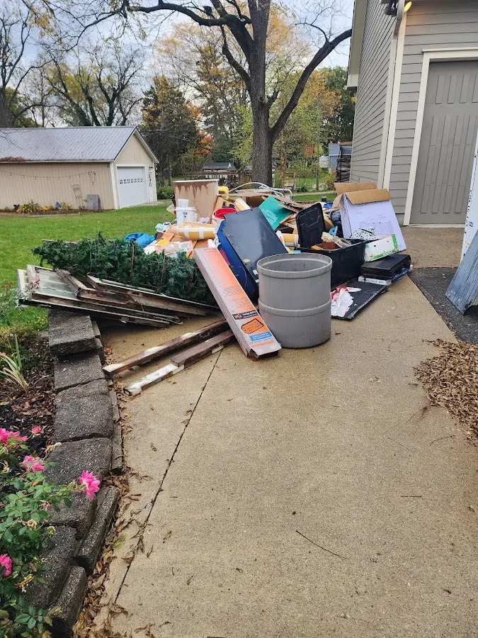 Dumpster being loaded with debris for 10 Yard Dumpster Rental in Pleasant View